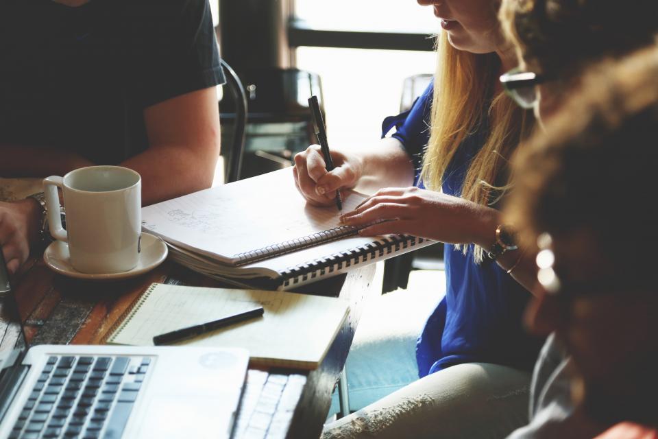 Team collaborating in a meeting room during a corporate language training program